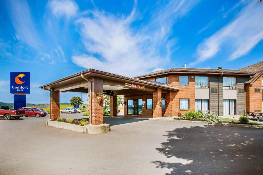 a hotel front of a building with a parking lot at Comfort Inn Sydney - Cape Breton in Sydney
