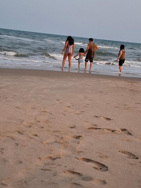 a group of people walking on the beach at Journeyman Ocean Deck in Marakkānam