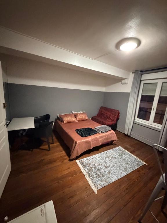 a bedroom with a bed and a couch and a table at Gengoult 3 in Toul