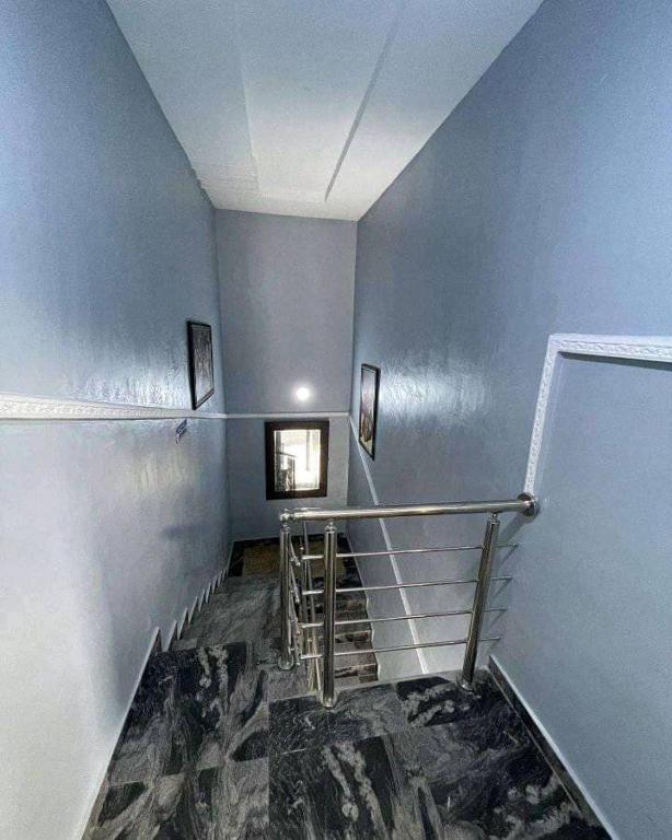 a staircase in a building with blue walls at Beatrice apartment services in Warri