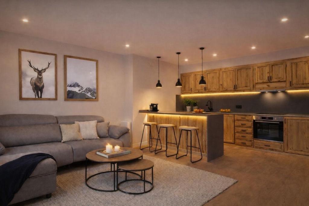 a living room with a couch and a kitchen at Luderna - Apartamento con terraza Artigues in Arties