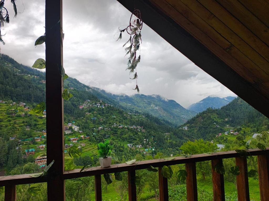 a view from a window of a mountain valley at Offbeat Trails in Jibhi
