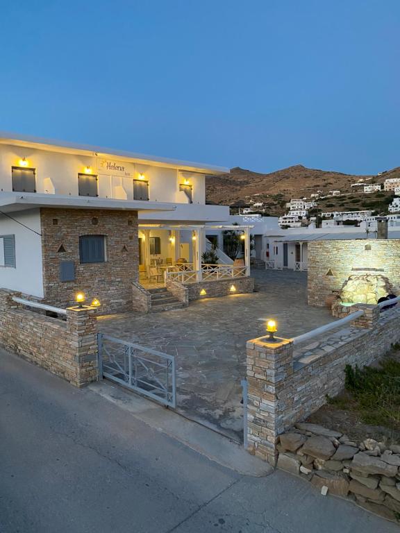 a house with a fence and a stone driveway at Hotel Helena in Ios Chora
