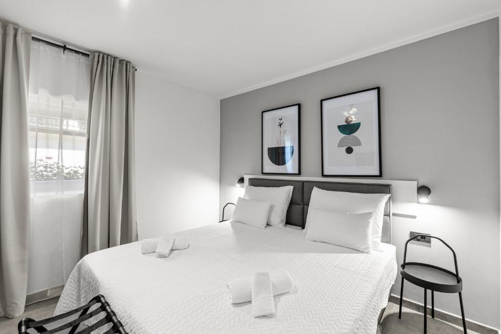 a black and white bedroom with a bed and a window at Konoba Most Rooms in Buzet