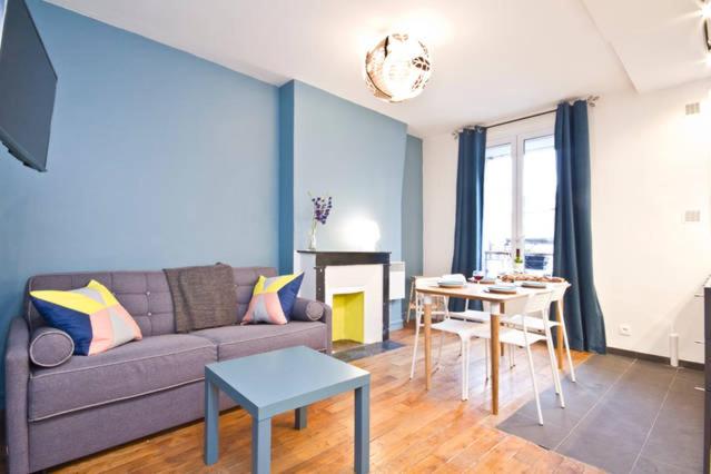 a living room with a couch and a table at Bright and Newly Renovated Apartment, Hip Canal Saint-Martin Area, Central Paris in Paris