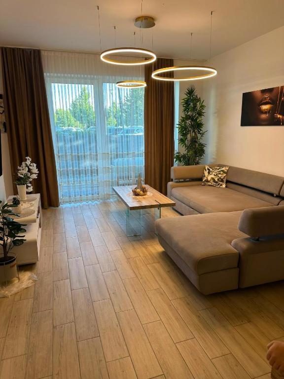 a living room with a couch and a table at Golf Green Resort - Hesperus 2 in Hrubá Borša
