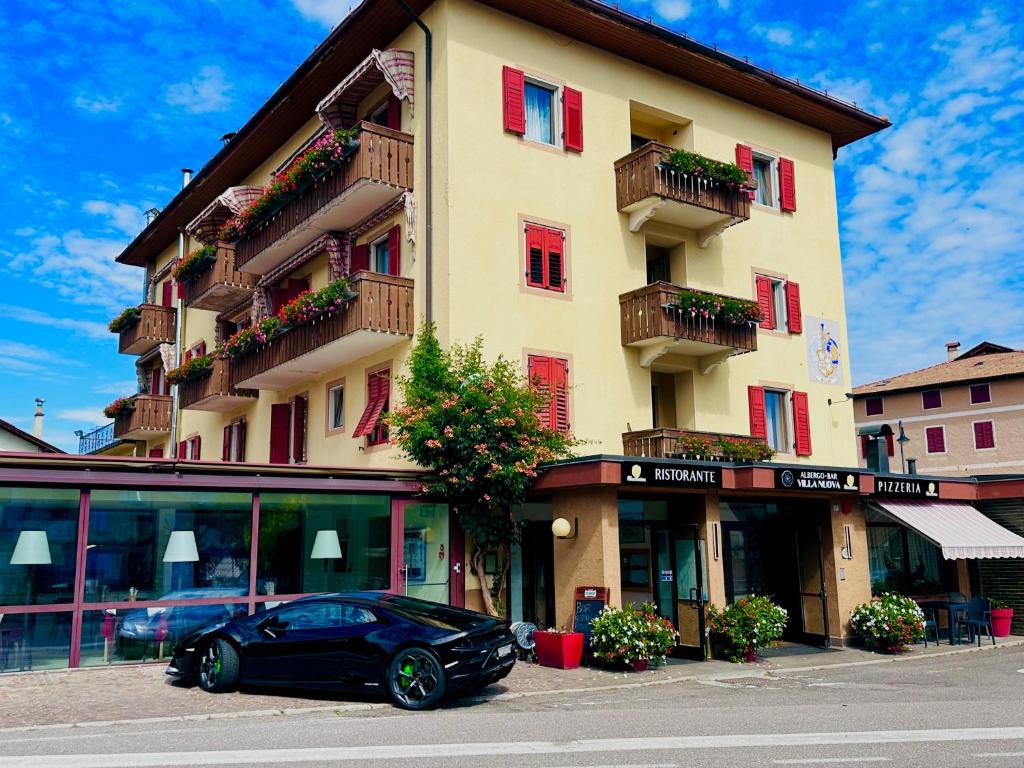 a black car parked in front of a building at VILLA NUOVA in Romeno