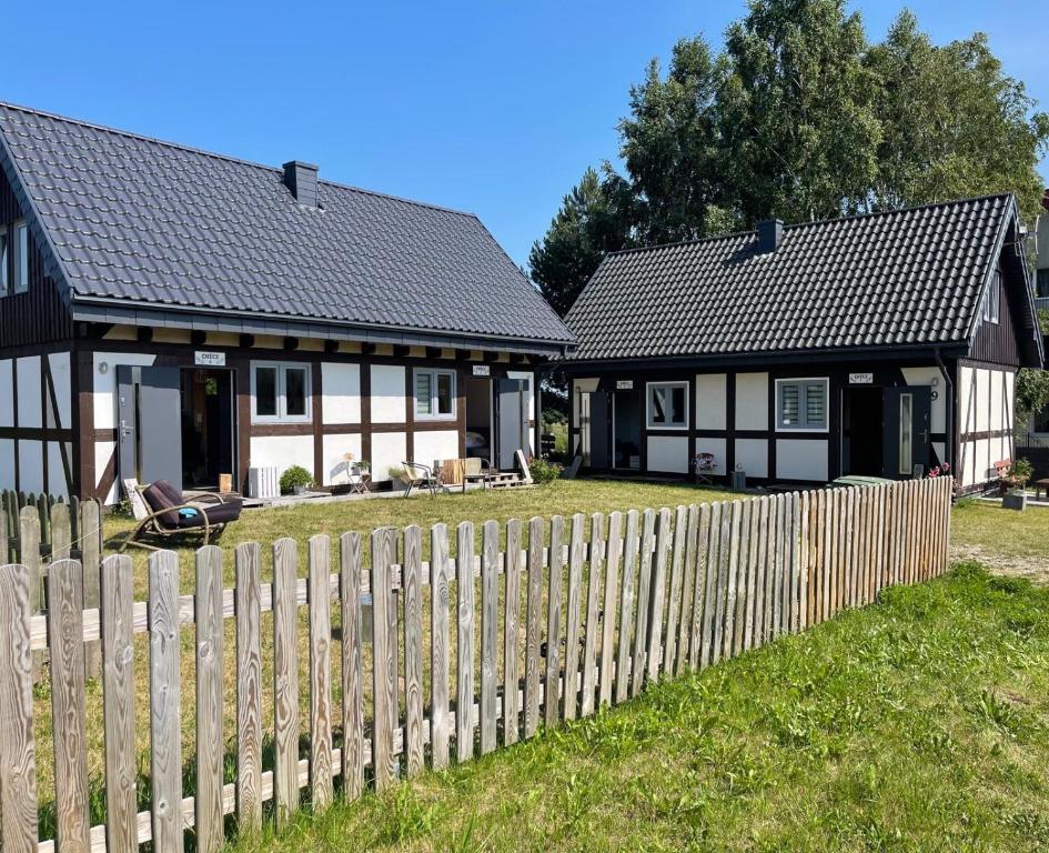 a house with a fence in front of it at Zagroda Nadmorska Brzezina in Jastrzębia Góra