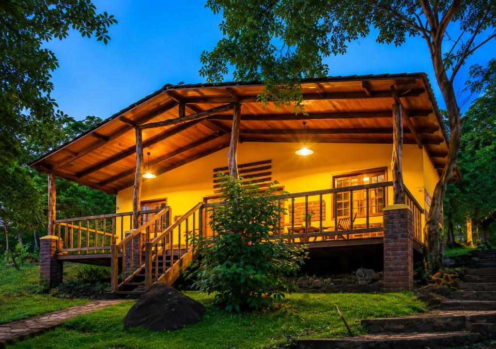 a house with a large deck in the yard at Congos Lodge in El Perú