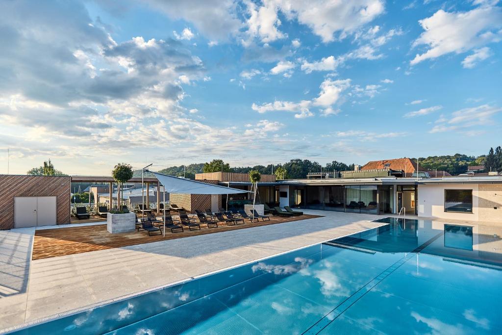 a swimming pool on the roof of a house at Landhotel Wratschko - Wirtshaus - Gamlitz - ehem Hotel am Marktplatz in Gamlitz