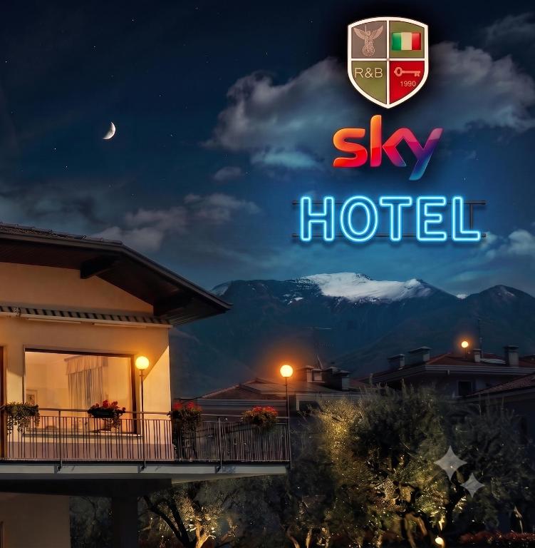 a sign for a hotel at night with a mountain at R&B Casa Wanda since 1999 in Riva del Garda