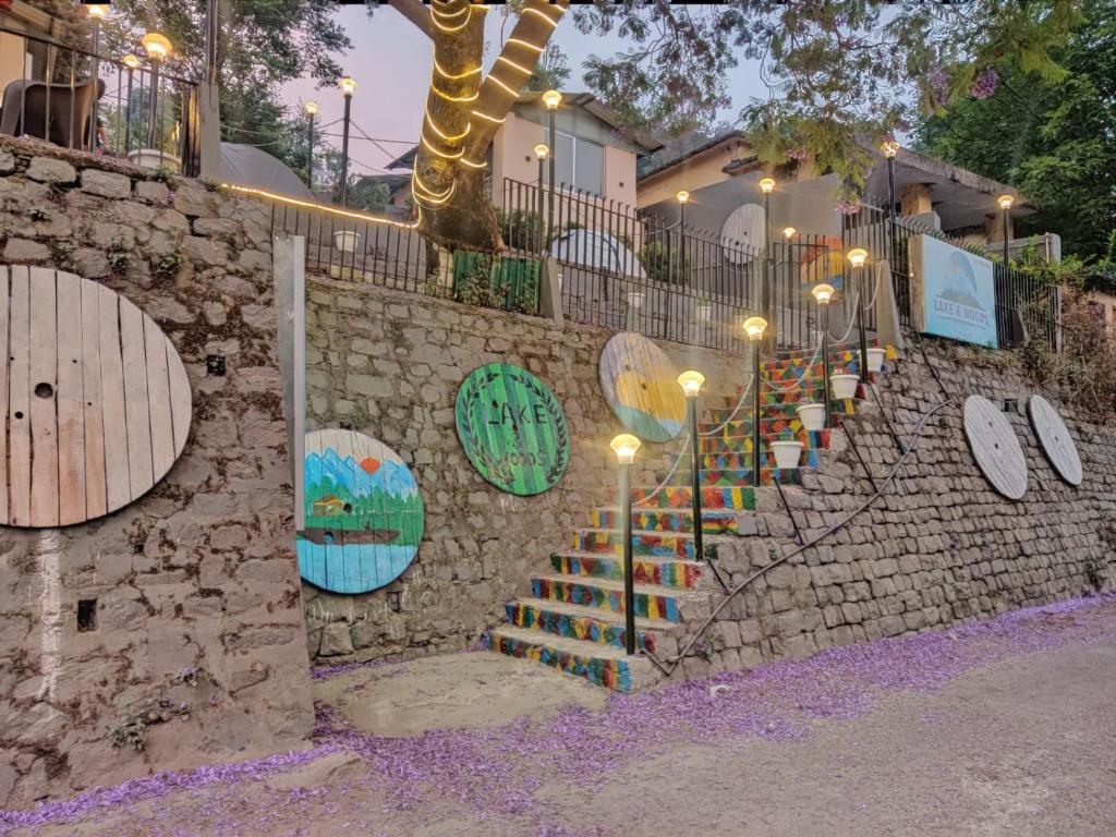 a stone wall with a staircase with skateboards on it at लेक एंड वुड्स in Bhīm Tāl