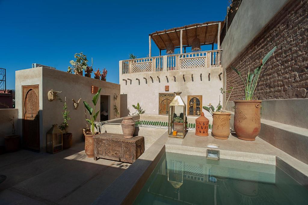 a house with a swimming pool next to a building at Marrakech Medina - Private Riad 4 rooms Rooftop and pools in Marrakesh