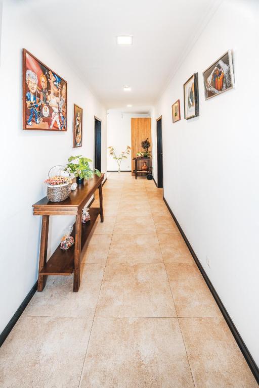a hallway with white walls and a tile floor at Marcos Hotel in Nizhnyaya Alekseyevka