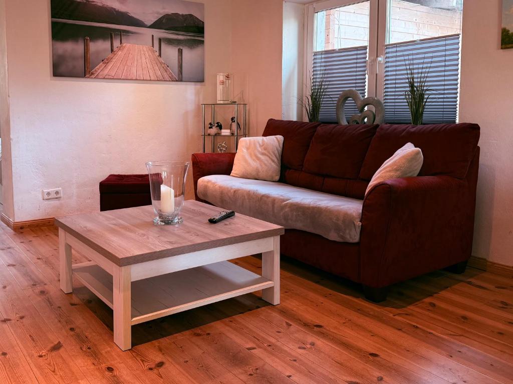a living room with a couch and a coffee table at Apartmenthaus Schlanow in Detmold