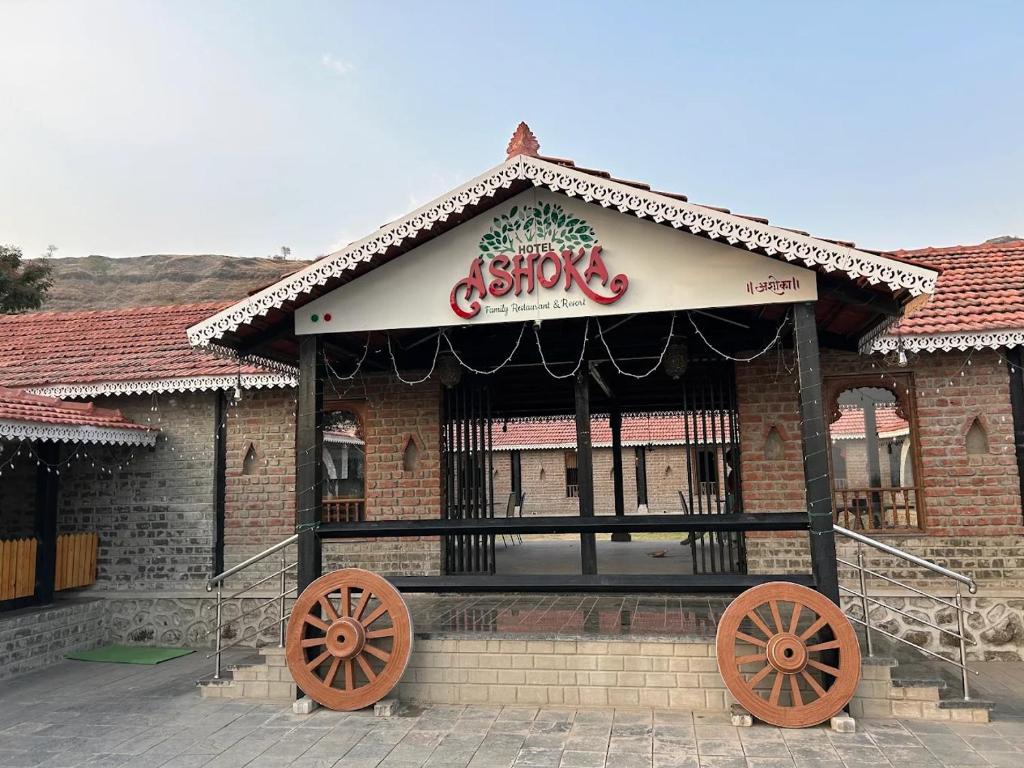 a building with a store withoked wheels in front of it at Ashoka Resort in Wai