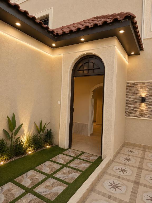 a home with a walkway leading to a door at منتجع الفيا - مسابح in Abha