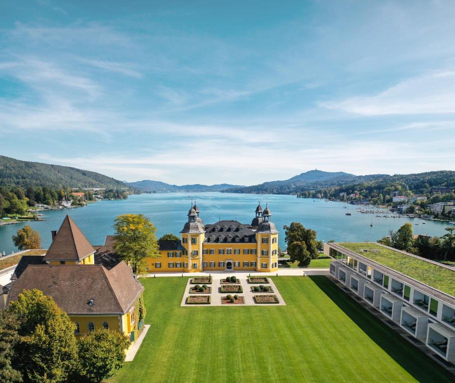 an aerial view of a large building with a large lawn at Falkensteiner Schlosshotel Velden – The Leading Hotels of the World in Velden am Wörthersee