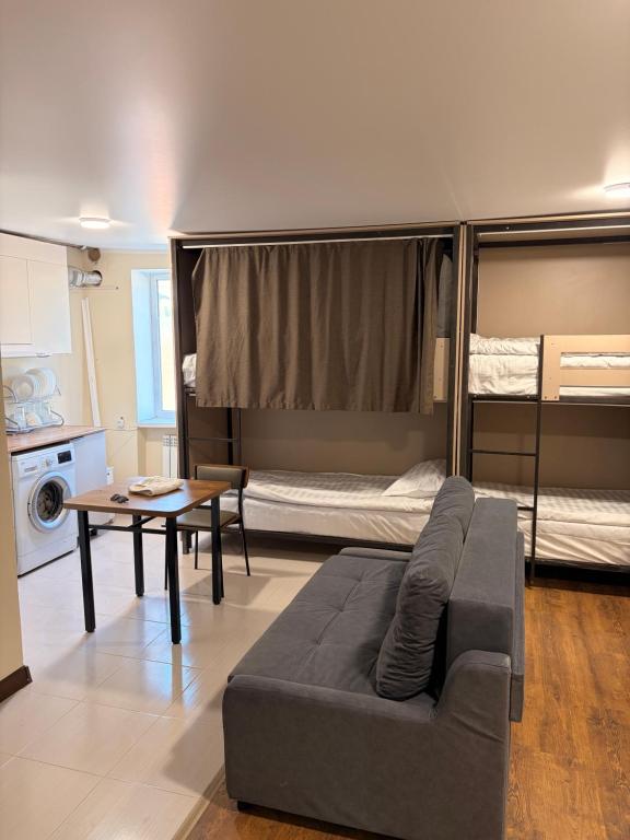 a living room with a couch and a bunk bed at Hostel 1869 in Karakol