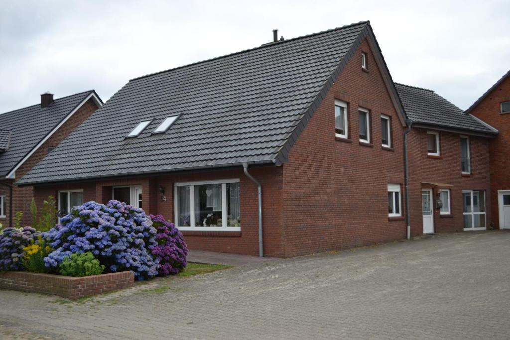 a brick house with flowers in front of it at Wohnen nahe der Ems in Fresenburg