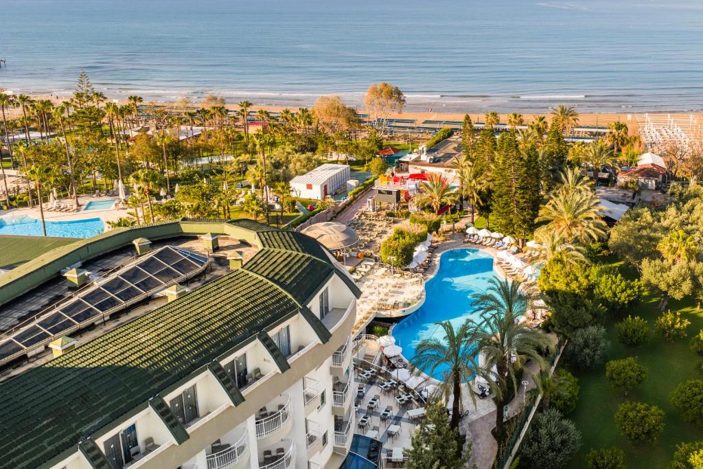 an aerial view of a resort with a pool and the ocean at SİDE SUN in Manavgat