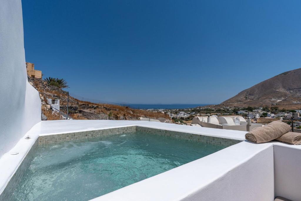 a swimming pool on the roof of a house at EG Cave Houses in Éxo Goniá