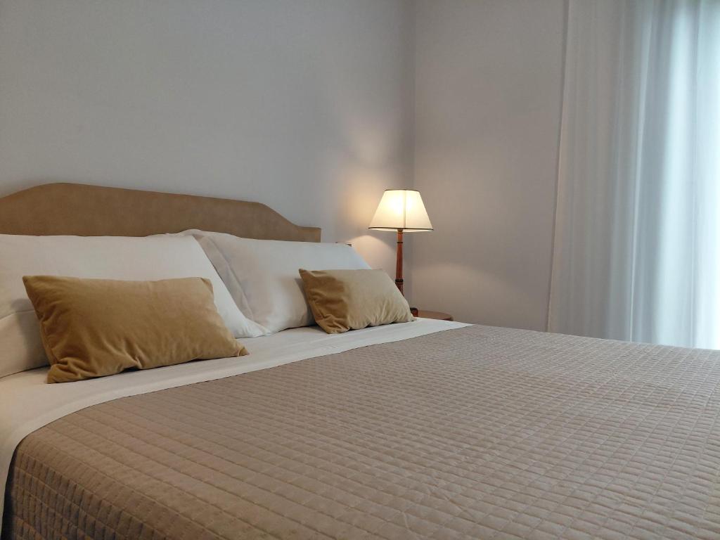 a bedroom with a large bed with two pillows at B&B Piazza Marconi in Castelpizzuto