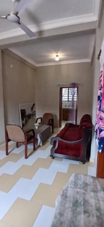 a living room with a couch and a table at Furyan Lodge in Cape Coast