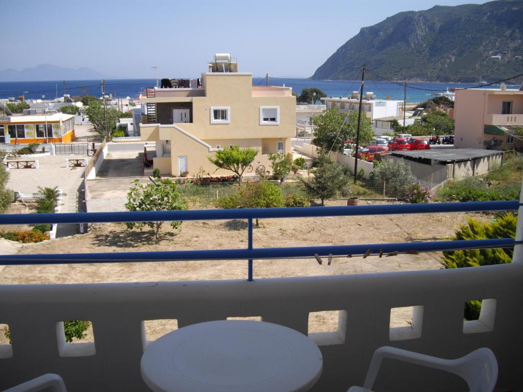 a balcony with a table and a view of a city at Fourtounis Hotel in Kefalos