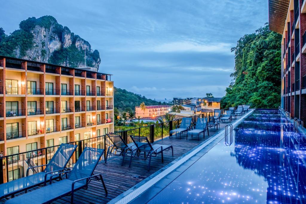a hotel with a pool in front of a building at Sugar Marina Hotel CLIFFHANGER Aonang in Ao Nang Beach