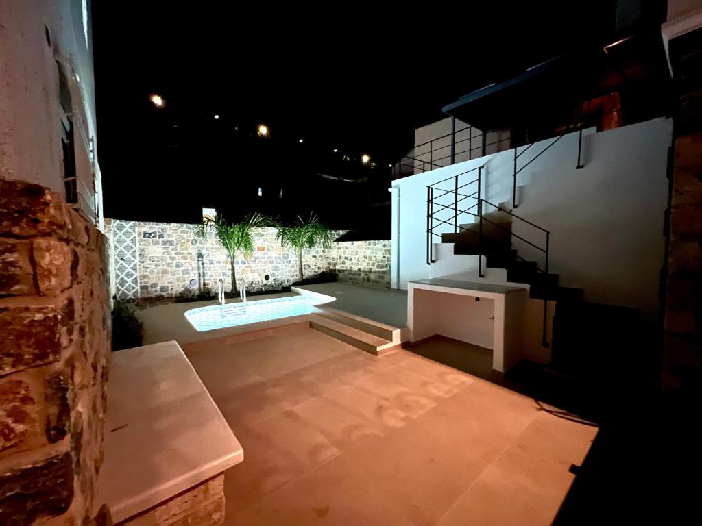 a view of a patio at night with a staircase at ARCHONTIKO Atsas - Amethystos in Kalymnos