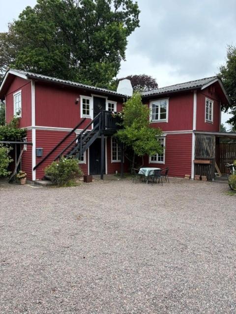 a red house with a staircase in front of it at Valhallsvägen 45 in Ängelholm