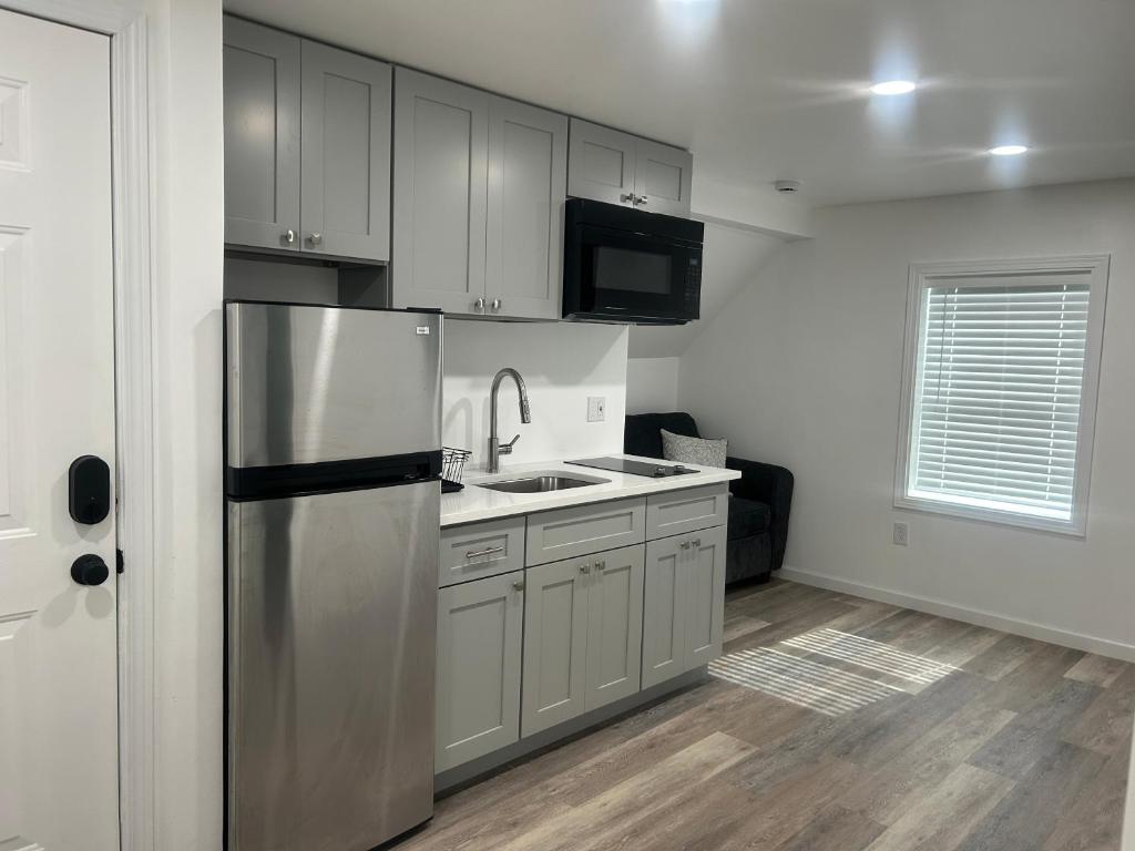 a kitchen with a stainless steel refrigerator and a sink at Loft Apartment by the River Fort Edward in Fort Edward