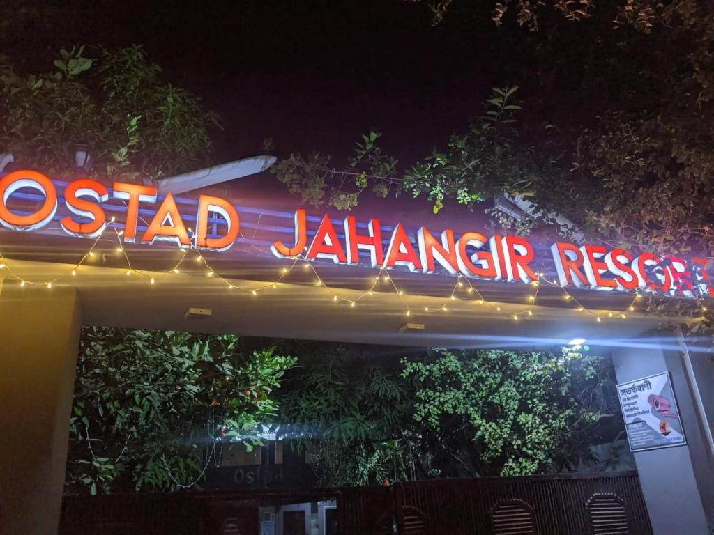 a neon sign for a seafood restaurant at night at Ostad Jahangir Resort in Cox's Bazar