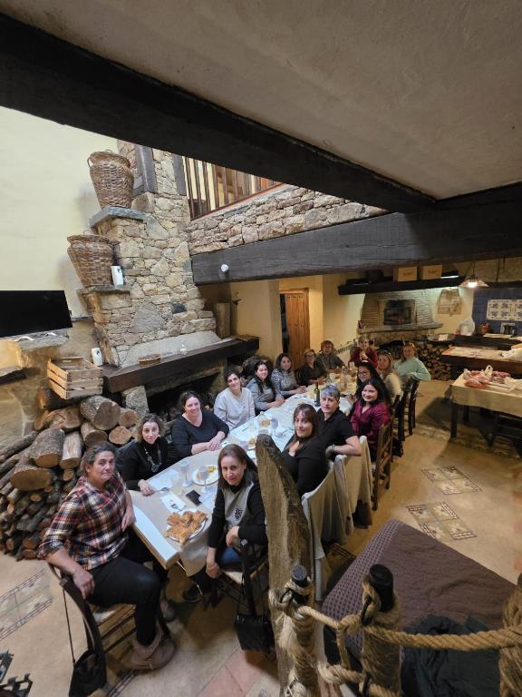 a group of people sitting at a table in a restaurant at Arribes del Duero casa rural Balneario, hotel rural Bermellar y Camino de Hierro in Bermellar