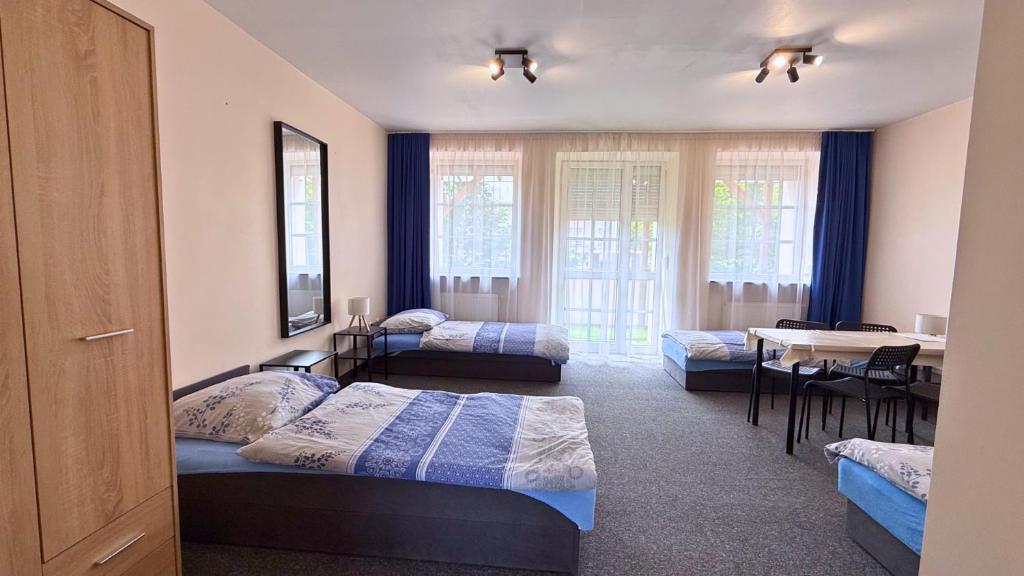 a bedroom with two beds and a table with a dining room at Noclegi Słodki Sen 2 in Lublin