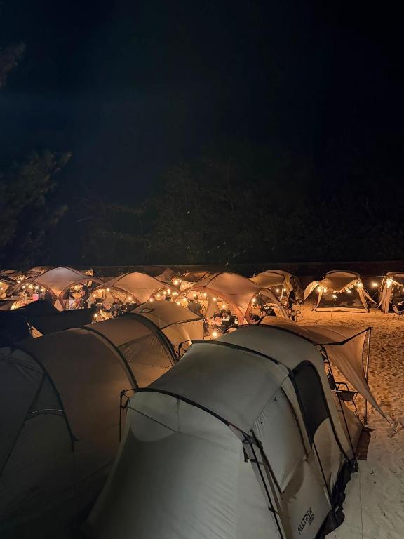 a group of tents on the beach at night at camp asri in Bukittinggi