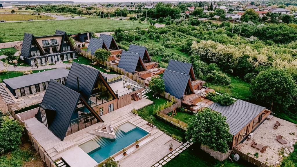 an aerial view of a house with a swimming pool at By The Lake - A Frame in Căciulaţi