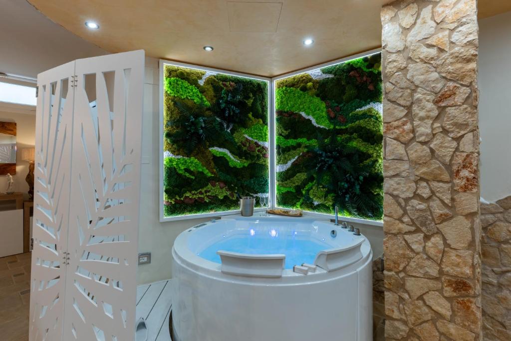 a large bathroom with a large window and a tub at SOLE e LUNA - JACUZZI e RELAX in Neviano