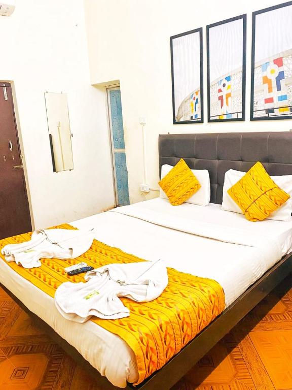 a bedroom with a bed with towels on it at Baga Beach Way in Baga