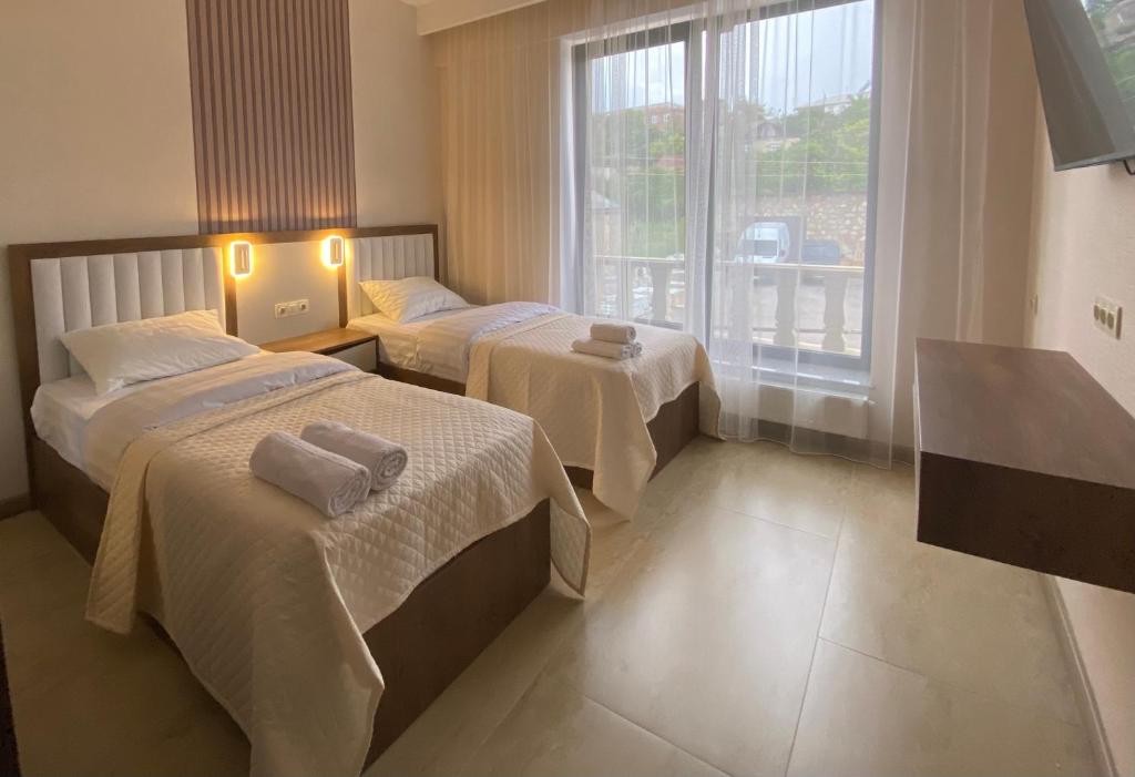 a hotel room with two beds and a window at Makaryan Resort in Artsvaberd