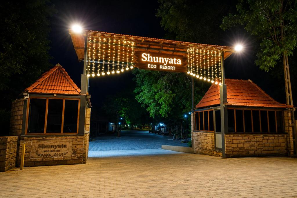a sign that reads shivkaka at night at Shunyata Eco Resort Junagadh in Vadal