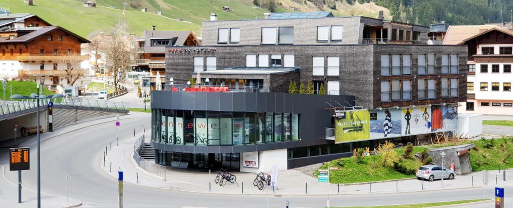 a large building in a city with a street at Pepis Skihotel in Sankt Anton am Arlberg