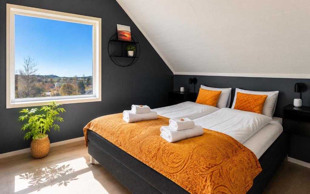a bedroom with a large bed with towels on it at KB - Nordic Lux Villa in Sørvågen