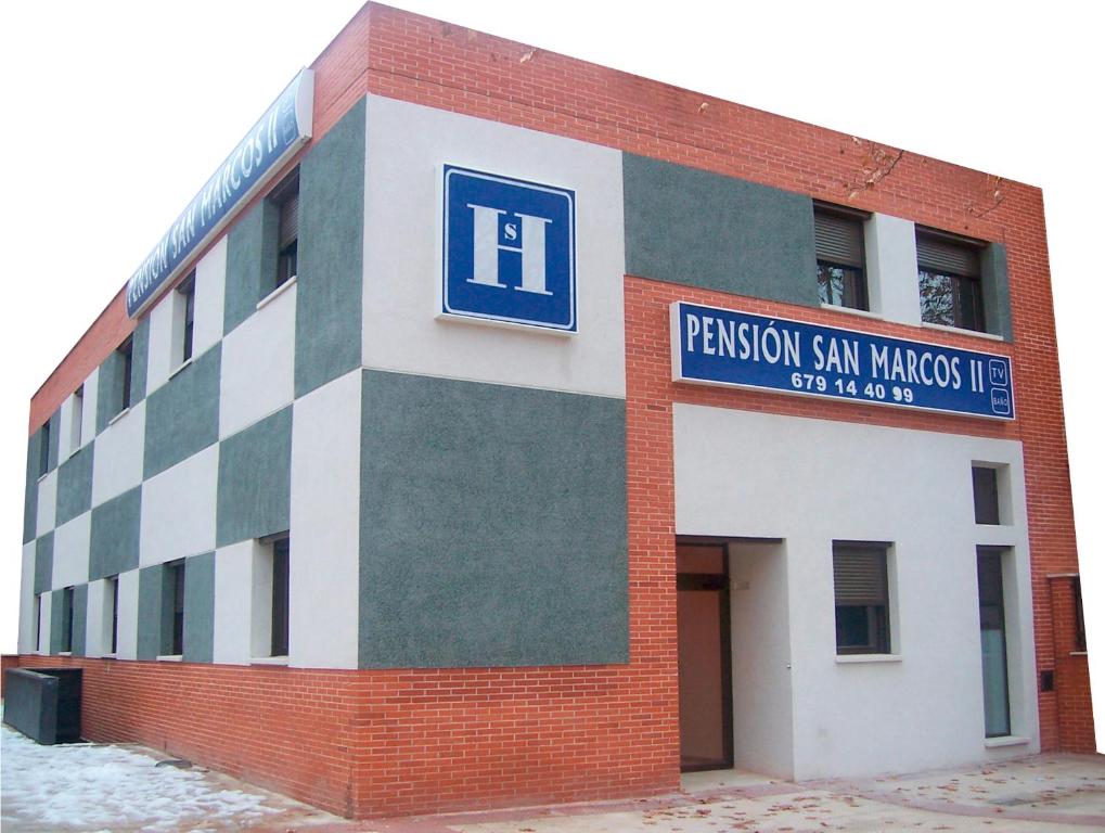 a brick building with a sign on the side of it at Hostal San Marcos II in Guadalajara