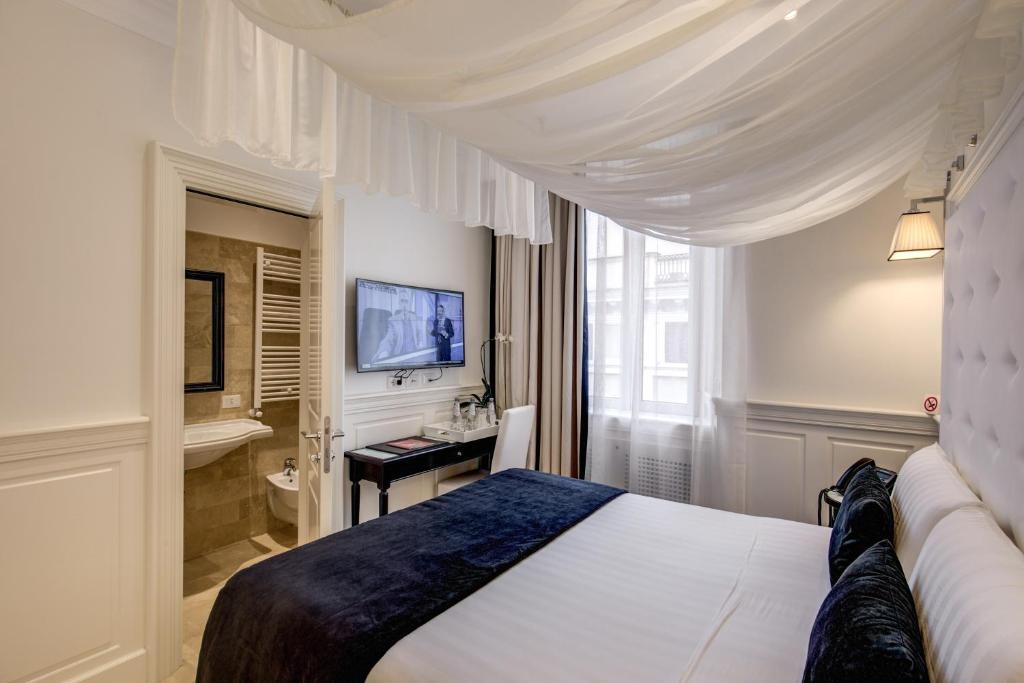 Postel nebo postele na pokoji v ubytování Hotel Tito