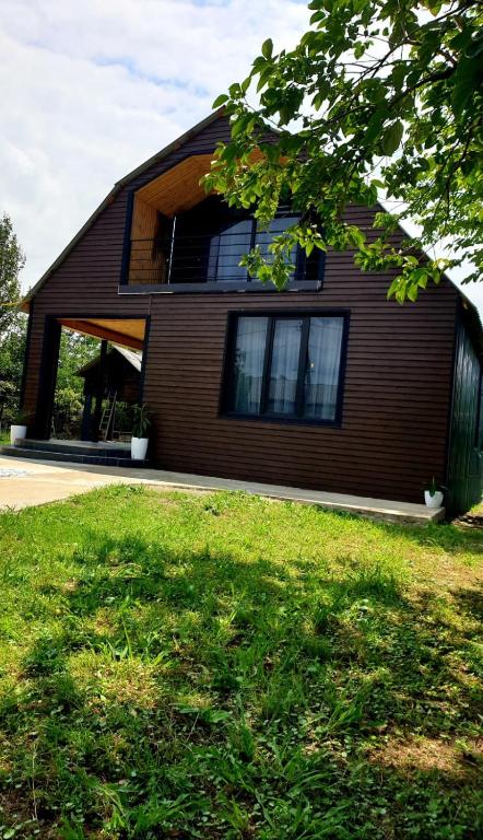 a house with a window on the side of it at George - Guest House Shekvetili in K'vemo Natanebi