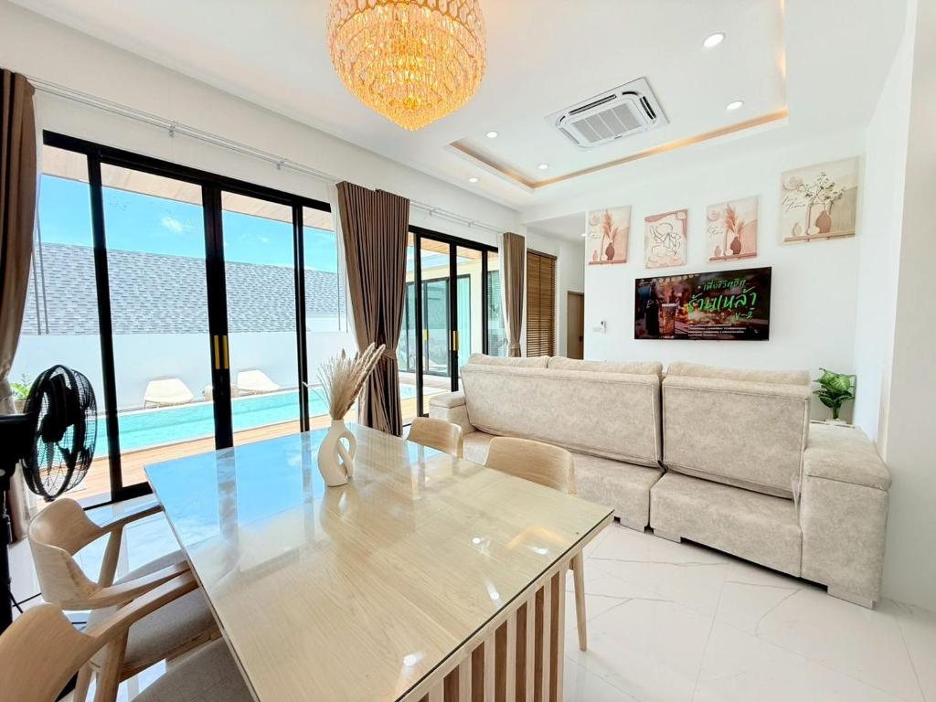 a living room with a couch and a table at Nook Villa in Ban Khlong Mae Nam