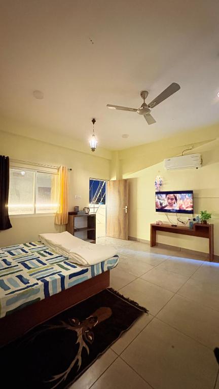 a bedroom with a bed and a flat screen tv at Platform 9 3by4 in Ujjain