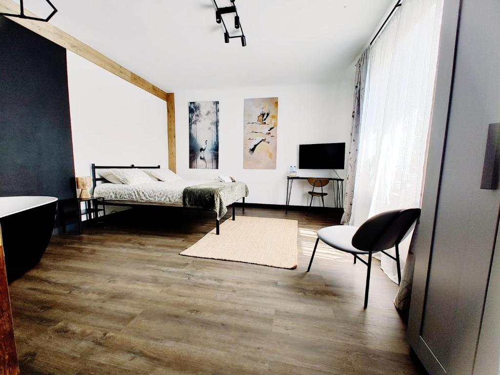 a bedroom with a bed and a television in it at Weekendowo Miejsce i Czas Agroturystyka in Wyszogród